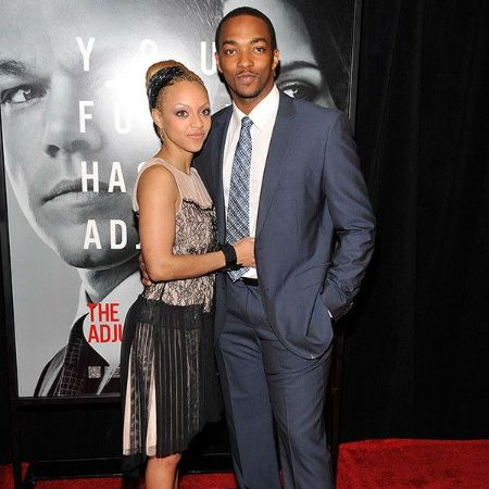 Anthony Mackie and Sheletta Chapital are posing on the red carpet.